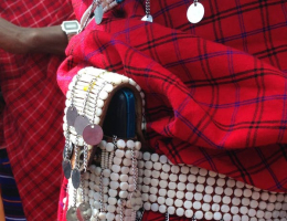 A Maasai man accessorizes with a beaded phone holder